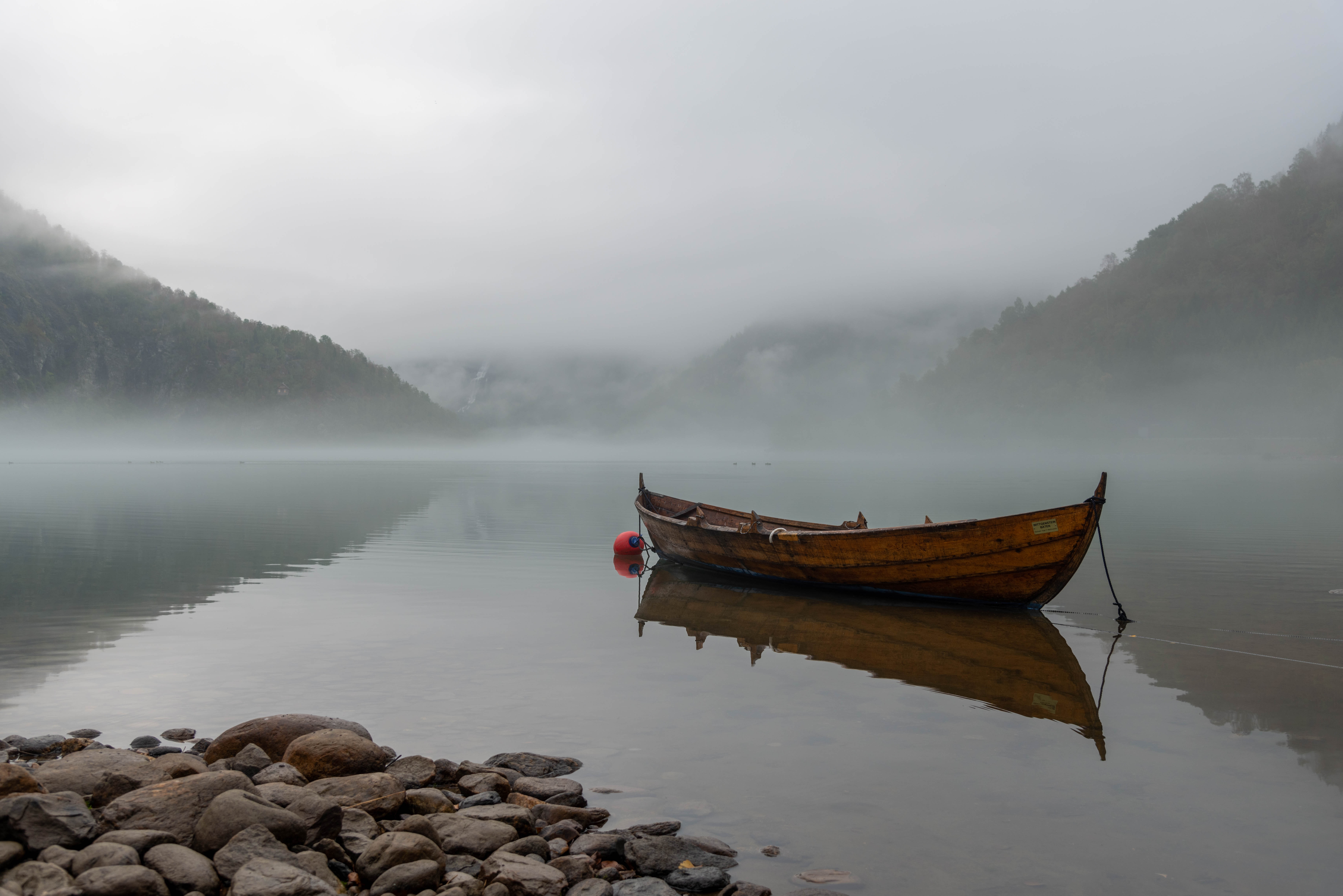 Skiff on a foggy lake